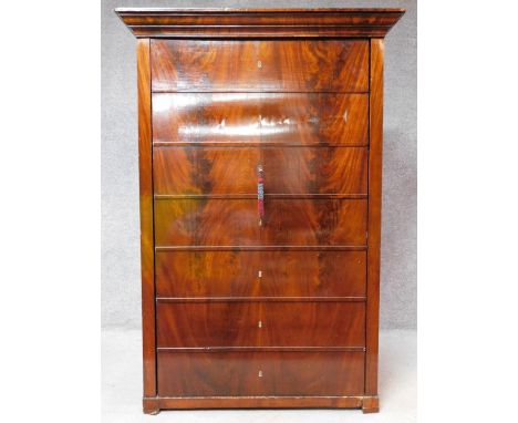 A 19th century Continental flame mahogany hall cupboard fitted with a panel door set with seven dummy drawers. H.157 W.107 D.