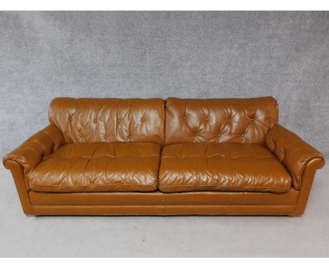 A vintage brown leather button backed sofa. H.72 W.220 D.90cm 