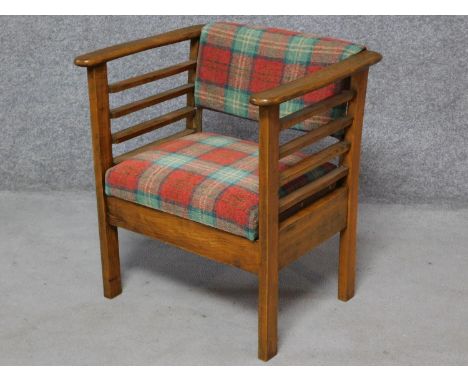 A vintage beech framed Utico patent action sliding music stool, makers label to the inside sheet music compartment. H.64 W.59