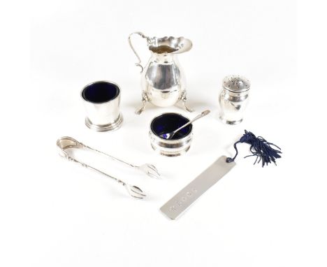 A collection of hallmarked silver items. The lot to include a Victorian cream jug, salts with fitted blue glass liners, a pep