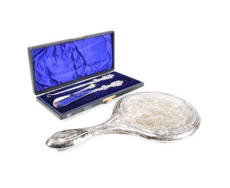 An early 20th Century hallmarked silver vanity mirror and cased set of silver handled items. The lot to include an Edward VII