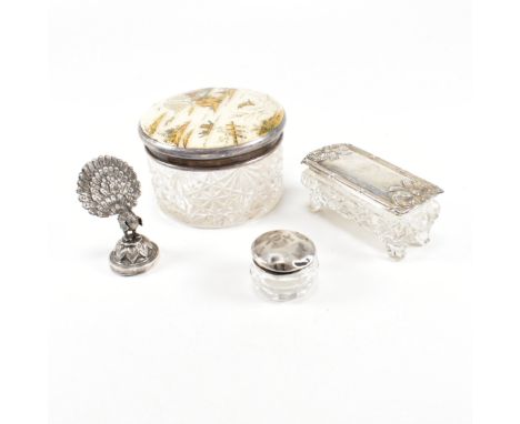 Three hallmarked silver and white metal lidded cut glass jars with card holder.&nbsp; To include a George V circular cut glas