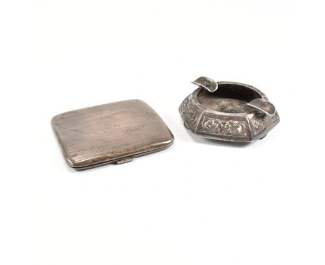 A 1920s hallmarked silver cigarette case and a silver ashtray. The George V cigarette case having an engine turned finish wit