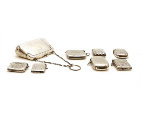 An early 20th century silver purse, with leather interior, by E.J Houlston, Birmingham 1919, together with seven vesta cases,