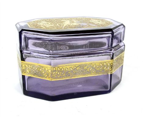 An amethyst glass trinket box, with gilt decorated top