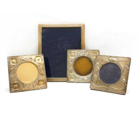 Four silver frames, comprising a pair by A &amp; J Zimmerman, embossed with flowers, 15.5cm high, another and a larger plain 