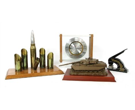 A collection of gentleman's libary items, to include a vintage embossing press, an artillary shell form desk tidy and a model