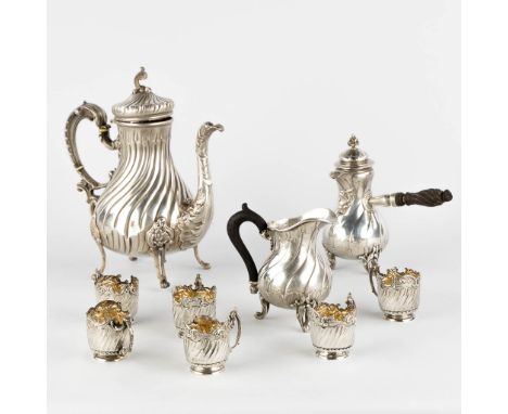 A Hot Chocolate pot, coffee pot and milk jug, 6 glass holders. Silver in Louis XV style. France.Marked with Minerva, first gr