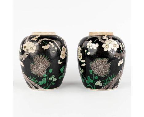 A pair of Chinese Famille Noir storage pots with blossoming tree decor. 19th/20th century.Condition report: - Both are missin