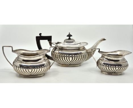 A three piece silver tea service, by William Aitken, Birmingham 1906-1909, comprising; teapot, twin handled sugar bowl and mi