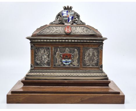 A Victorian presentation white metal and enamel oak mounted casket,&nbsp;with plaque to one long side engraved "From the Cons