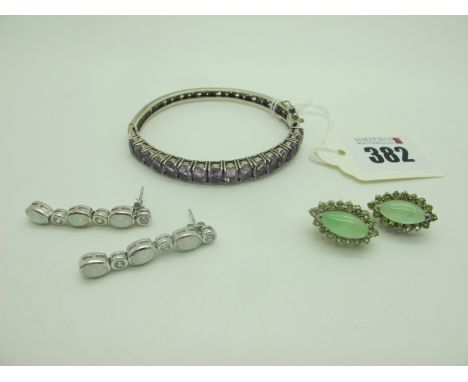 A Modern Hinged Bangle, uniform oval claw set to the front, hinged to snap clasp (stamped "925"); together with two pairs of 