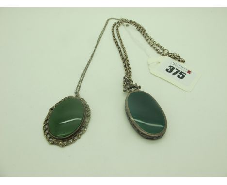 A Large Oval Panel Pendant, inset green and black, below scroll surmount, on a belcher link chain; together with a polished h