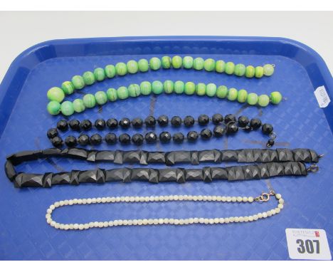 A Victorian Jet Style Panel Necklace of Alternate Geometric Design,  a French Jet style bead necklace, a mother of pearl bead