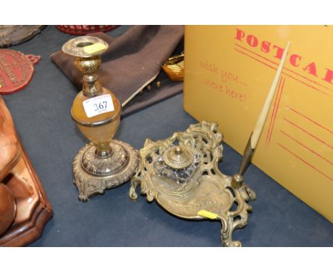 A decorative brass desk stand and similar candlestick