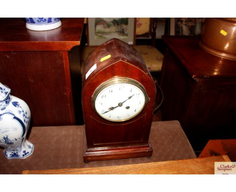An Edwardian mahogany and brass inlaid mantel clock with eight day movement