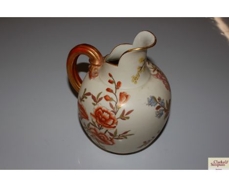 A Royal Worcester ewer with floral decoration on ivory coloured ground, heightened in gilt 