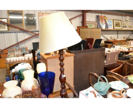 A turned wooden standard lamp and shade