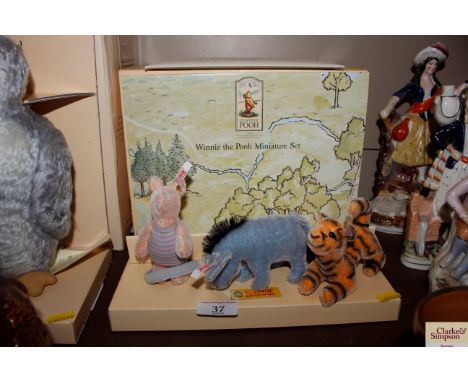 A Steiff "Winnie The Pooh" miniature set with box and certificate 