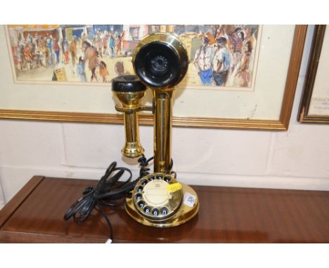 A brass candlestick style telephone 