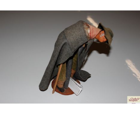 A Jouglas figure of a traditional French lady wearing cloak and hat
