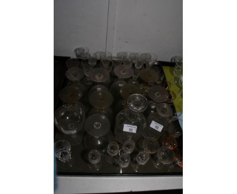 A number of panel cut wine glasses, champagne glasses, decanters, etc