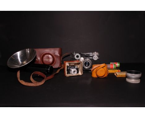 An Argus 35mm camera, in leather case, and a miniature Hit camera
