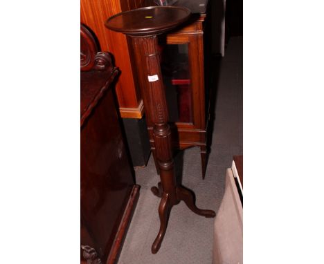 A Georgian design mahogany torchère with turned and reeded stem, on tripod base