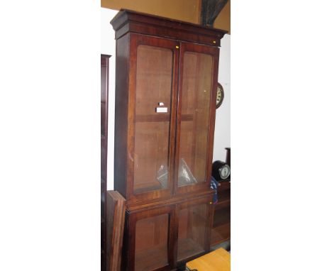 A 19th Century mahogany two-stage display bookcase enclosed glazed panel doors, on block base, 37" wide