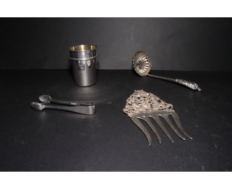 A sterling silver mug, a pair of silver sugar tongs, a continental serving fork (a/f) and a white metal sifter spoon with apo