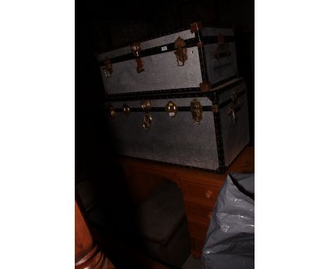 Two silvered metal cabin trunks and an ammunition case