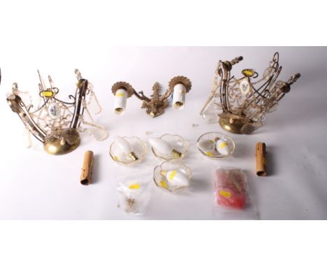 A pair of gilt metal two-branch wall lights hung glass drops and floral porcelain panel and another gilt metal wall light