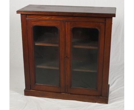 A Victorian mahogany side cabinet enclosed two glazed arch panel doors, 39" wide