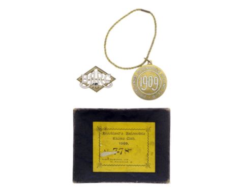 Two BARC Brooklands lapel badges, 1909numbered 778, comprising one Member's badge with cord and one guest's badge, in white e