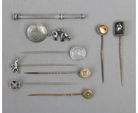 A collection of antique stick pins, one set with a diamond and a white metal propelling pencil.