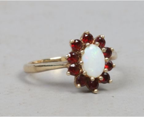 A 9ct gold garnet and opal cluster ring, size N.