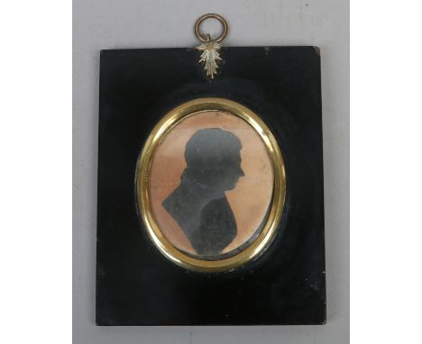 A C19th silhouette portrait miniature inscribed verso, cut with common scissors by Master Hubard (aged 13 years) without draw