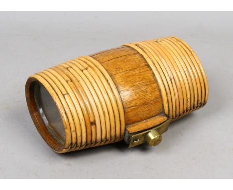 A vintage oak spirit flask of barrel form bound with cane with glass panels and brass cover.