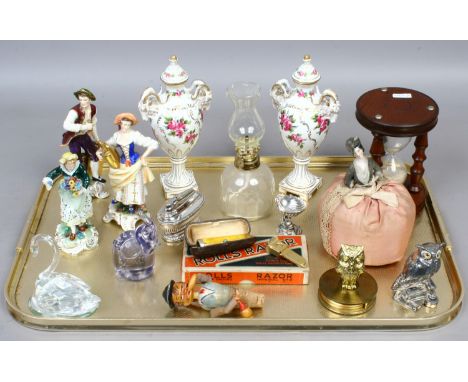 A tray of collectables including a pair of Dresden urn vases, half doll, continental china figures, a vintage Ronson desk lig