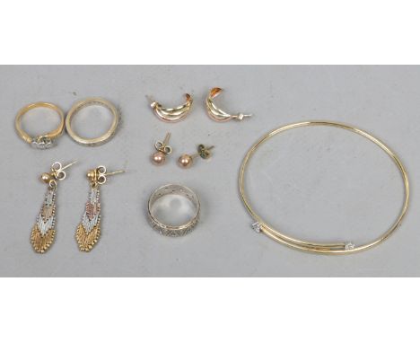 A collection of yellow metal jewellery to include bangle, earrings and rings.