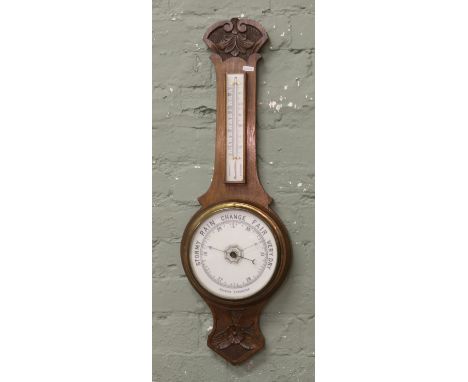 A carved oak banjo barometer.