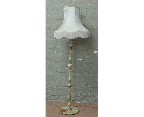 An onyx and gilt metal standard lamp with green shade.