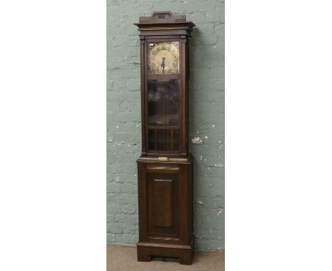 An Edwardian oak longcase clock, marked W Greenwood Leeds Half hour chiming on a coiled gong   Condition Report. To be used a