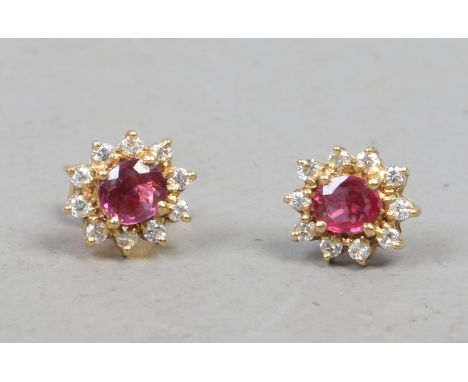 A pair of 18ct golf ruby and diamond ear studs, one back missing.