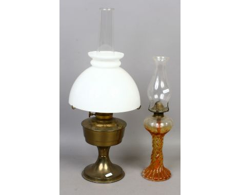 A large brass base oil lamp, along with a smaller glass base oil lamp.