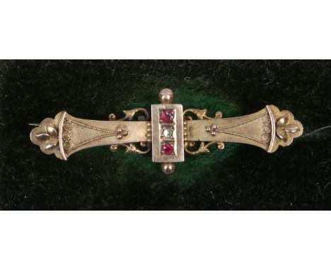 A Victorian cased 9ct gold bar brooch set with ruby and diamond, assayed Chester 1899.