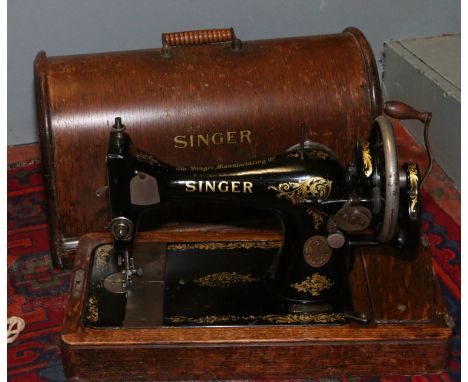 An oak cased vintage Singer sewing machine.
