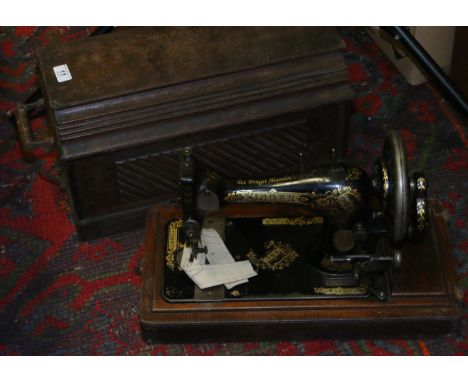 A vintage oak cased Singer sewing machine.