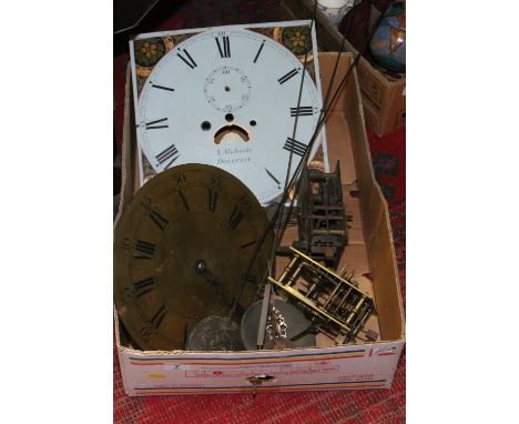 A box of antique clock parts including brass and painted longcase dials, movements, pendulums etc.