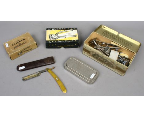 A collection of vintage barbers accessories including a cased cut throat razor, hair clippers etc.